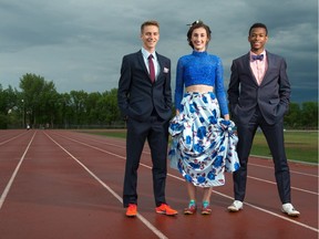 From left, Matthew Exner, Chloe McEachern and Vaughn Taylor stand in their grad clothing on the track at the Canada Games Athletics Complex.