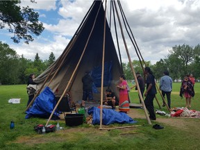 The Justice for Our Children camp teepee had its canvas taken off temporarily around Sunday noon so a sacred eagle feather could be removed. The canvas was put back on, and camp supporters said they have no intention of leaving as they passed the government's noon deadline to have the teepee removed.