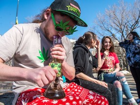 Regan Macdonald takes a pull on his Bart Simpson themed bong in Victoria Park in Regina where marijuana enthusiasts had gathered to smoke.