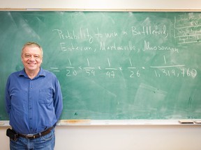 Andrei Volodin, a professor of statistics at the University of Regina, stands next to an equation spelling out the probability of Prairie Sky Cannabis winning a cannabis retail license in four different locations in the province's recent lottery.
