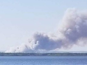 So far this year, 227 wildfires have burned throughout the province. Pictured here is the Tuff fire, viewed from Waterhen Lake in central Saskatchewan on May 19, which destroyed 13 cottages in the Flotten Lake subdivision.