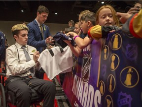 Surviving member of the Humboldt Broncos Ryan Straschnitzki, left, and Reagan Poncelet sign autographs on the fan red carpet prior the NHL awards at the Hard Rock Hotel in Las Vegas, NV on Tuesday, June 20, 2018.