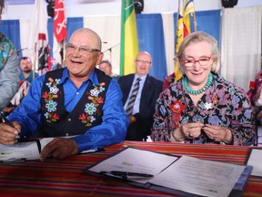 Metis Nation-Saskatchewan president Glen McCallum (left) and federal Minister of Crown-Indigenous Relations Carolyn Bennett (right) sign a historic accord at Batoche, Saskatchewan on Friday, July 20, 2018