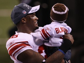 Will Blackmon celebrates on the field at Lucas Oil Stadium with his son, Ryder, after the New York Giants defeated the New England Patriots 21-17 to win the 2012 Super Bowl.