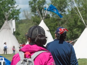 Visitors view the Justice for our Stolen Children camp across from the Saskatchewan legislative building.