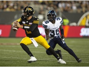 Hamilton Tiger-Cats quarterback Johnny Manziel and Toronto Argonauts defensive back Truman Washington on June 1, 2018.