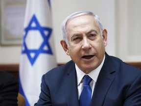 Israeli Prime Minister Benjamin Netanyahu chairs the weekly cabinet meeting at his office in Jerusalem, Sunday, July 15, 2018. Israeli Prime Minister Benjamin Netanyahu says Justin Trudeau was among those who personnally asked that Israel evacuate hundreds of so-called White Helmets from Syria amid fears they would be attacked by government troops.