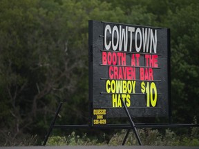 A billboard advertises $10 cowboy hats being sold by Cowtown at its location near the Craven bar, outside the festival grounds.