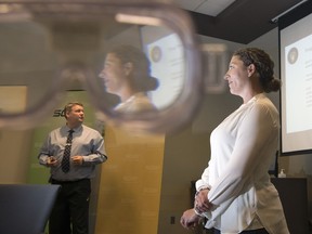 RCMP Cpl. Brian Ferguson, left, Provincial Drug Recognition Evaluations (DRE) Training Co-ordinator, and Regina Police Service Cpl. Shannon Gordon, DRE trainer, speak at SGI about the techniques used to detect impaired driver in Regina. A pair of impaired simulation goggles were used to distort the background through the eyepieces.