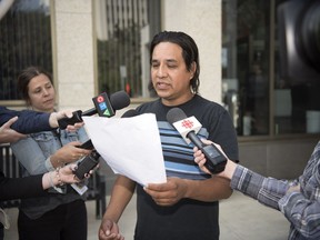 Simon Ash-Moccasin reads a settlement of the legal actions involving Simon Ash-Moccasin and the Board of Police Commissioners for the City of Regina.