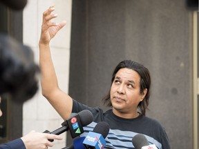 Simon Ash-Moccasin speaks to reporters on the steps of Court of Queen's Bench in Regina on Friday, July 27, 2018.