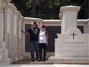 Jenny Migneault, right,  and her partner Orlando Fantini walk through the Saskatchewan War Memorial in Wascana Centre in Regina.