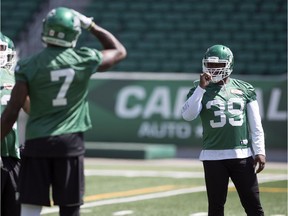 Charleston Hughes, 39, shown talking with fellow Saskatchewan Roughriders defensive end Willie Jefferson, 7, at practice on Tuesday, is to face his former Calgary Stampeders teammates Saturday at Mosaic Stadium.