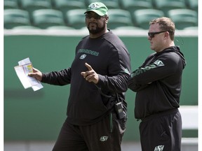 Offensive co-ordinator Stephen McAdoo, left, talks with Riders head coach Chris Jones during a recent practice at Mosaic Stadium.