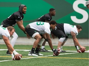 Brandon Bridge, standing left, and David Watford are being rotated at quarterback by the Saskatchewan Roughriders.