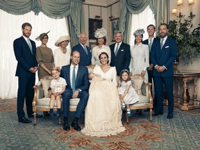 In this handout image released by the Duke and Duchess of Cambridge, (Seated left to right) Prince George, The Duke of Cambridge, Prince Louis, The Duchess of Cambridge, Princess Charlotte, (Standing left to right) The Duke of Sussex, The Duchess of Sussex, The Duchess of Cornwall, The Prince of Wales, Mrs. Carole Middleton, Mr. Michael Middleton, Mrs. Pippa Matthews, Mr. James Matthews, Mr. James Middleton pose for an Official Portrait following the christening of Prince Louis taken in the Morning Room at Clarence House in St James's Palace on July 9, 2018 in London, England.
