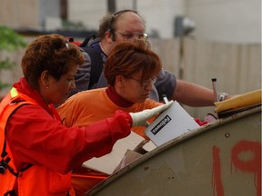 In this Leader-Post photo from July 7, 2004, Belinda Whitecap, left, and Dawn McNab, centre, from Carry the Kettle First Nation along with Richard Rickwood with Amateur Radio Emergency Services search dumpsters in an alley in the 1700 block of Ottawa Street for any sign of five-year-old Tamra Keepness. Reported missing July 6, she was last seen at her home on the 1800 block of Ottawa Street around 11 p.m. on July 5.