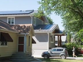 Matthew Pointer walks up the driveway to his home on Cameron Street. Pointer is a committee member with the Wascana Solar Co-operative and his house has solar panels affixed to its roof.