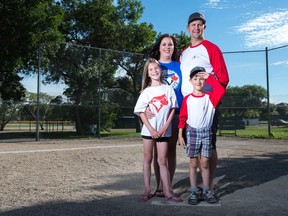 Kids Payton Wagman, front left, and Austin Wagman stand with their parents Amy Wagman, back left, and Matthew Wagman at a baseball diamond at Kinsmen Park North where Regina Challenger Baseball takes place.
