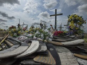 Hockey sticks, messages and other items at a memorial for the Humboldt Broncos bus crash at the intersection of highways 35 and 335 inside the the Rural Municipality of Connaught, SK on Wednesday, August 1, 2018.