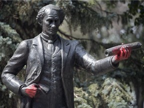 Someone has sprayed red paint on the Sir. John A. Macdonald statue in Victoria Park in Regina.
