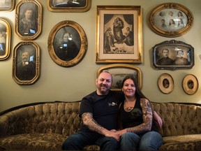 Rob and Karen Baron sit on an antique couch in the living room of their Regina home.