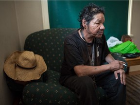 Dean Wapan, who is getting alcohol deliveries from Phoenix Residential Society's managed alcohol program, sits in the living room of his home on Edgar Street.