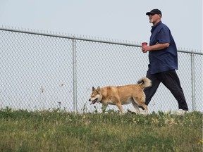 REGINA, SASK : August 17, 2018  -- James Stewart walks his dog Kai along the perimeter of the Ross Industrial off-leash dog park on Solomon Crescent. BRANDON HARDER/ Regina Leader-Post