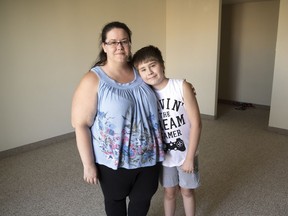 Angelique Pepin and her 11-year-old son Sean stand inside their still-vacant new home on Hanbidge Crescent. Their previous apartment was lost to fire on Aug. 11, 2018.