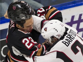 The Calgary Hitmen's Justyn Gurney (now of the Regina Pats) and the Vancouver Giants' Aidan Barfoot, right, square off in a WHL game this past February.