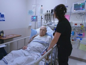 An image from the I Will Report campaign video, showing registered nurse Jenny (right) with a patient.