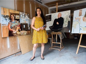 Artist Madhu Kumar stands near some of her unfinished work from her painting series "The Stories of Immigrant Women."