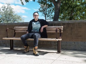 Elias Lachance,  executive director of Trans Umbrella Foundation and a member of the non-binary community, sits on a bench outside of Saskatchewan Polytechnic.