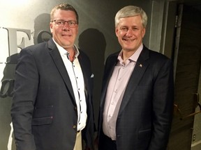 Premier Scott Moe and former Prime Minister Stephen Harper in attendance at a Saskatchewan Roughrider game in July.