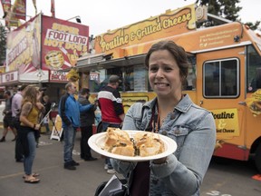 Leader-Post reporter Jennifer Ackerman tries cricket grilled cheese sandwich at the Queen City Ex in Regina.