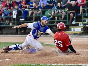 Colton Wright, 25, of the Medicine Hat Mavericks slides into home plate as Regina Red Sox catcher Matt Deneau on Tuesday night at Currie Field.