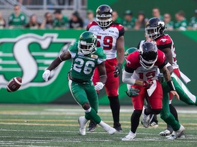 Calgary Stampeders quarterback Bo Levi Mitchell fumbles after being sacked by the Saskatchewan Roughriders' Charleston Hughes during Sunday's CFL game at Mosaic Stadium.