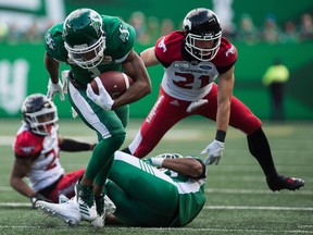 REGINA, SASK : August 19, 2018  -- Saskatchewan Roughriders wide receiver Shaq Evans (1), carries the ball past Calgary Stampeders defenders during a game at Mosaic Stadium. BRANDON HARDER/ Regina Leader-Post