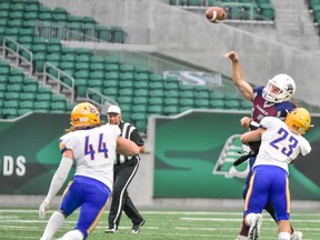 Regina Thunder quarterback Brock Sich releases a pass in the face of pressure from the Saskatoon Hilltops' Logan Bitz, 23, in Prairie Football Conference action Saturday at Mosaic Stadium.