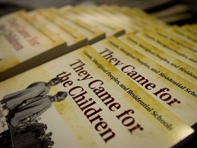 Historical books detailing residential schools released by the Truth and Reconciliation Commission sit on a table as the commission releases an interim report during a news conference in Vancouver, B.C., on Friday February 24, 2012.