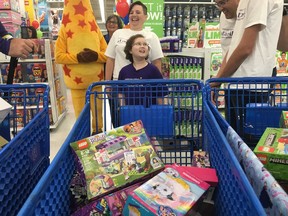 Amanda Powers was diagnosed with acute lymphoblastic leukaemia two years ago, before her seventh birthday. On Thursday morning, Amanda had the chance to race through a Regina Toys "R" Us store with her family and filled six shopping carts with as many free toys as possible within a three-minute timeframe. Austin Davis/REGINA LEADER-POST