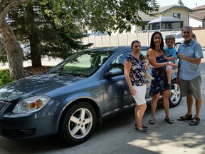 Sara Lefave and her son Lincoln were recently presented with the keys to a 2005 Pontiac by Andrew and Karen Martens of Regina Supercars.