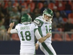 Saskatchewan Roughriders teammates Brett Lauther, right, and holder Josh Bartel celebrate after a game-winning, 56-yard field goal against the Toronto Argonauts on Saturday.