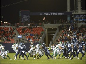 Saskatchewan Roughriders' Brett Lauther (fourth from left) kicks a game-winning, 56-yard field goal against the Toronto Argonauts on Saturday.