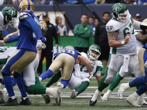 Saskatchewan Roughriders quarterback Zach Collaros gets hit by Winnipeg Blue Bombers' Jeff Hecht during the fourth quarter Saturday at Investors Group Field. Collaros was forced to leave the game and undergo concussion protocol.