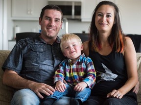 Jennifer Yim-Rodier, right, sits with her son Lucas Rodier, centre, and husband Anthony Rodier at their home in Pilot Butte. Yim-Rodier makes art to promote the awareness of and reduce the stigma around infertility.