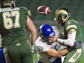 UBC Thunderbirds' Dante Vigini hits University of Regina Rams quarterback Noah Picton and pops the ball loose at Mosaic Stadium on Friday.