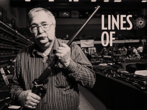 Ernie Gazdewich, a firearms vendor, stands at his display at a gun show being held at the curling rink in Canora, Saskatchewan.