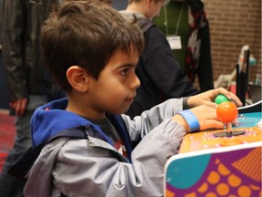 A young gamer tests a video game called Mighty Chamelion Brothers at Sunday's Regina Video Game Development Showcase, part of the QC Anifest convention.