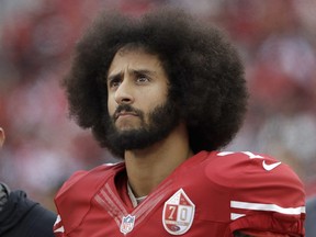 In this Dec. 11, 2016, file photo, then-San Francisco 49ers quarterback Colin Kaepernick stands in the bench area during the second half of the team's NFL football game against the New York Jets in Santa Clara, Calif.